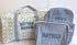 Two blue toiletry bags with embroidered names on a white background
