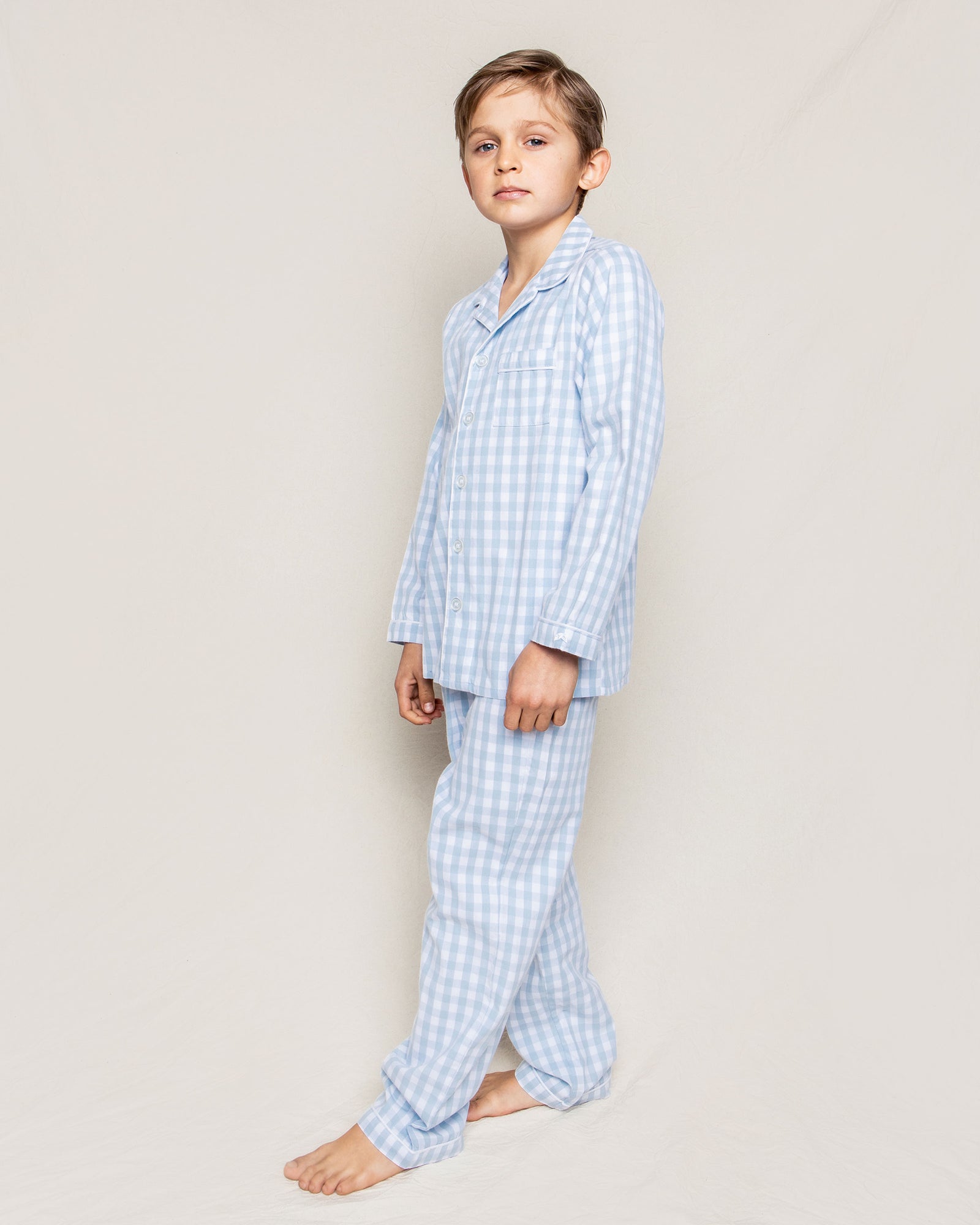 Model wearing Kid's Twill Pajama Set - Light Blue Gingham.